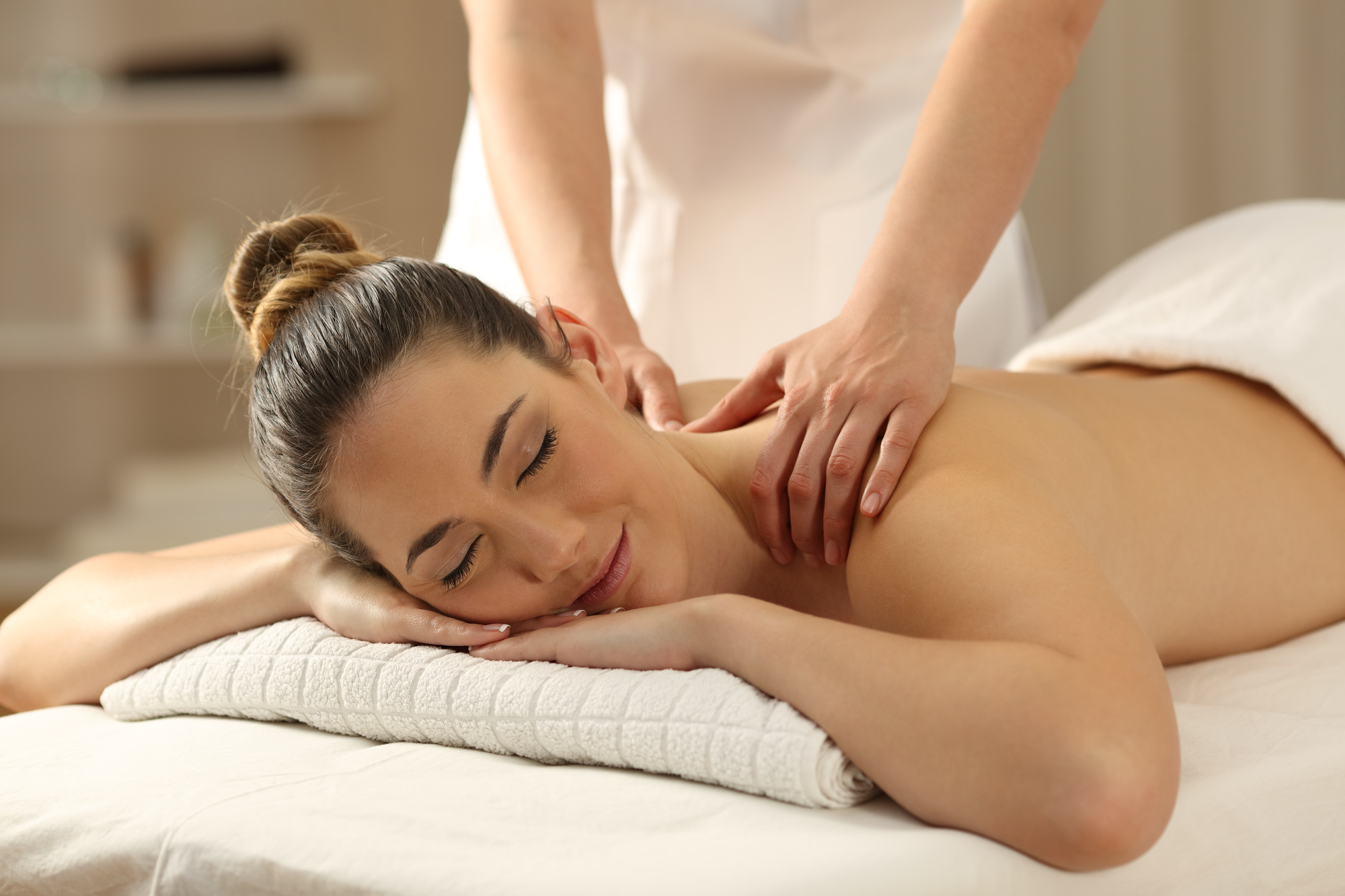 relaxed lady receiving a massage in a spa